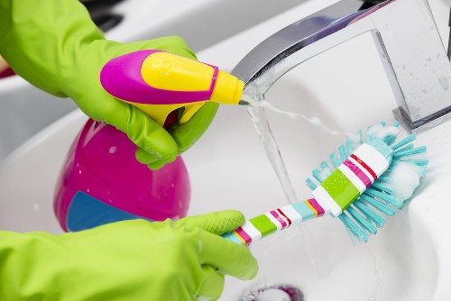 Professional domestic cleaner working in a Chelsea townhouse living room