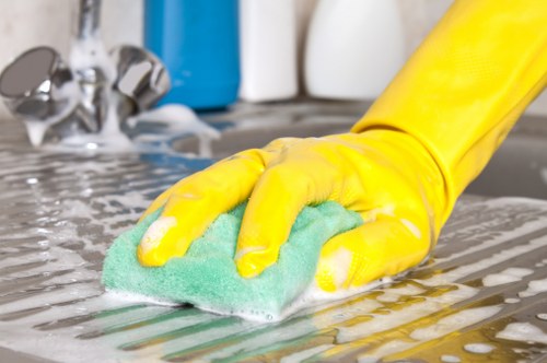 Local oven cleaner working in a Chelsea apartment kitchen